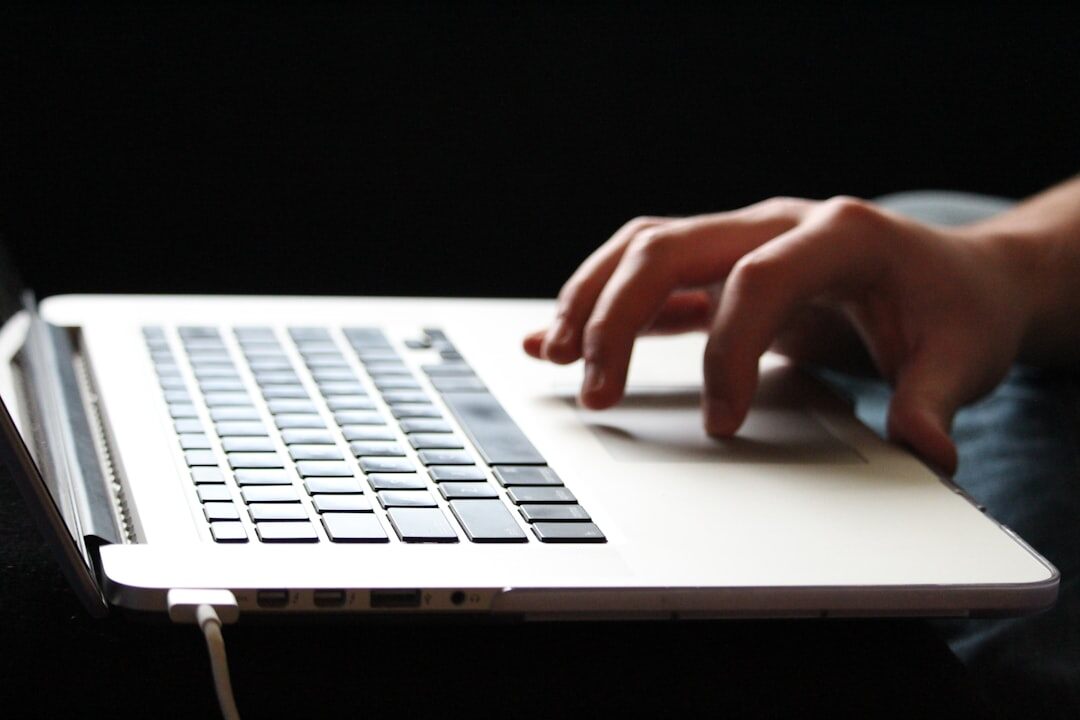 mystery writer typing on laptop