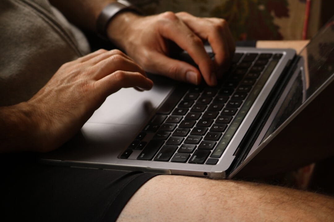 mystery writer typing on laptop